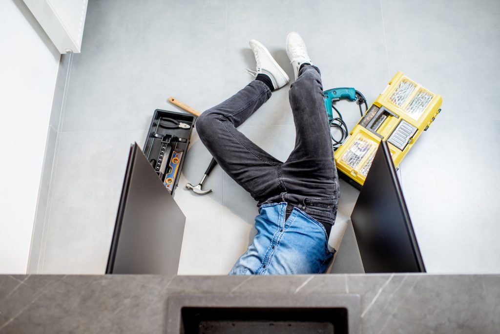 Man repairing kitchen plumbing